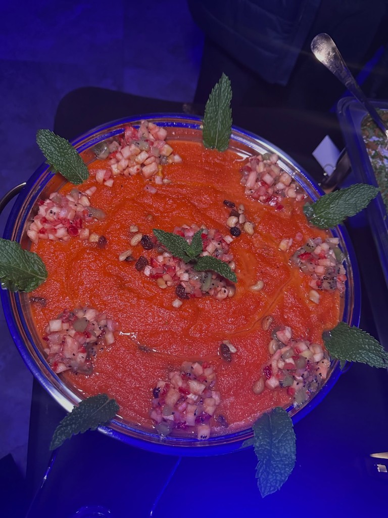 Gajar ka halwa garnished with fresh fruit and mint leaves