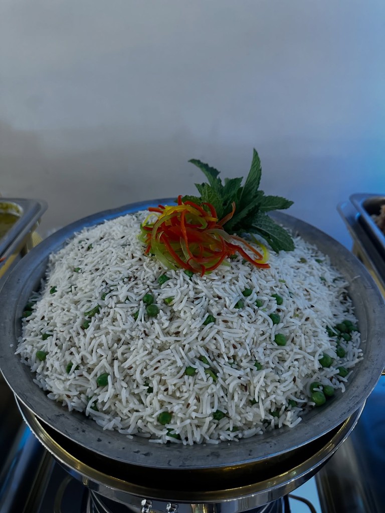 Fragrant jeera rice with green peas and fresh herb garnish