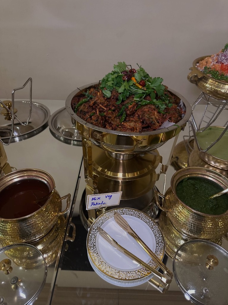 Mix veg pakoda buffet spread with mint and tamarind chutneys