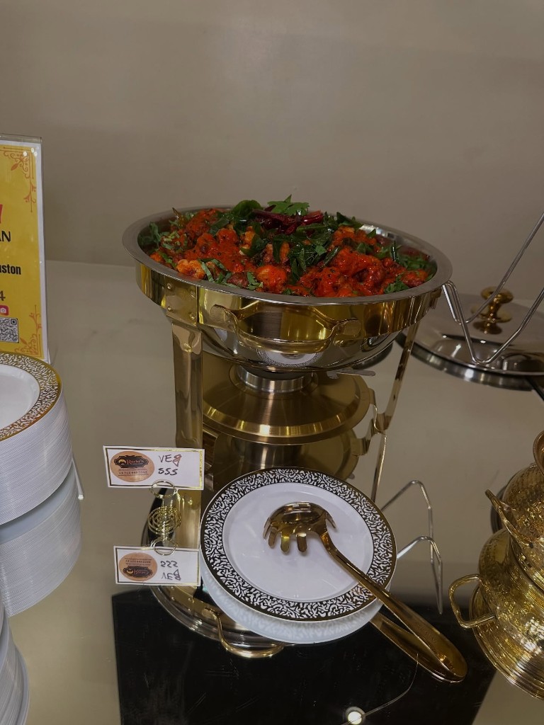 Spiced vegetable curry served in an elegant gold chafing dish